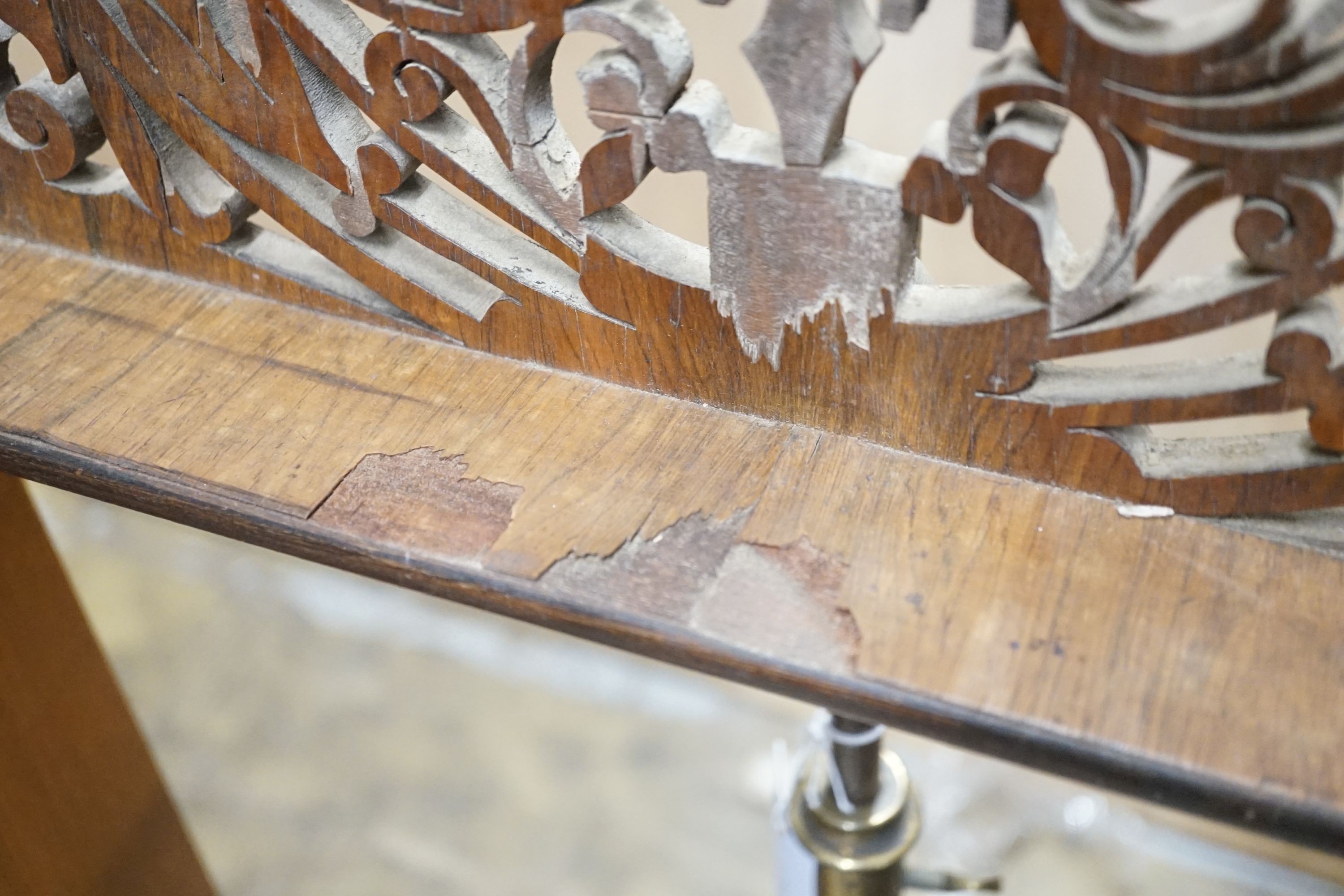 A Victorian rosewood pole screen and a fret cut music stand